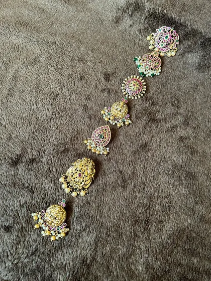 A collection of Kemp stone hair clips (jadanagam billai) to adorn your bridal braid. You can rent these individually or as a set.