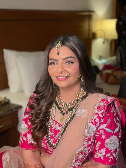 This bride chose to wear her hair down in soft, glamorous waves for her wedding. It's a beautiful choice for a modern bride who wants to feel comfortable and look stunning.