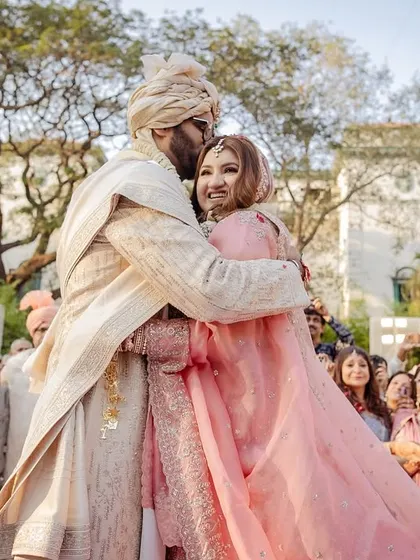 A beautiful embrace, with all their loved ones smiling in the background.