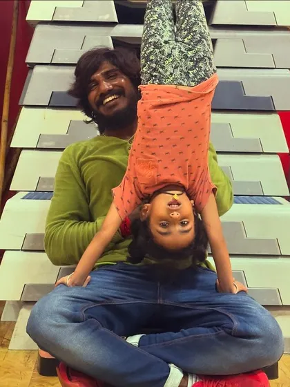 The bond I share with my students is special. Here, I'm helping one of my youngest kiddos with a fun, inverted yoga pose.