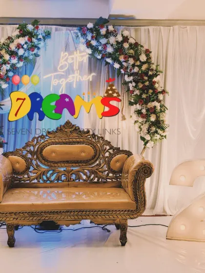 This is a classic setup for a 25th anniversary celebration. I designed a floral arch with red and white roses and included large marquee numbers to highlight the silver jubilee milestone.