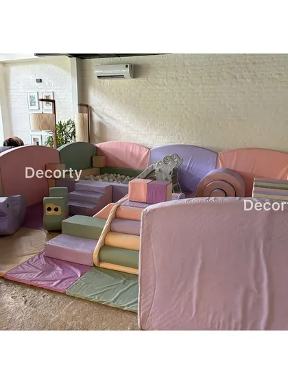 A pastel-colored soft play area provides a safe and fun zone for the youngest party guests to tumble and play.