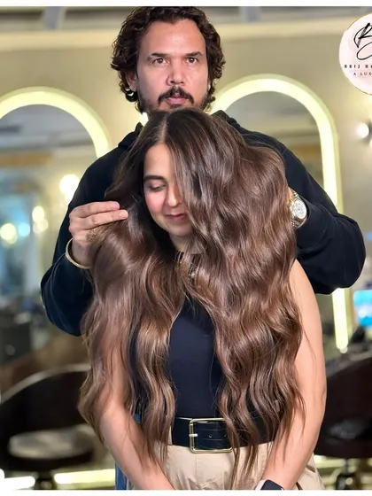 Look at the health and shine on this long hair. We created soft, flowing waves with a rich brown color that adds dimension and speaks for itself. This is confidence in every single strand.