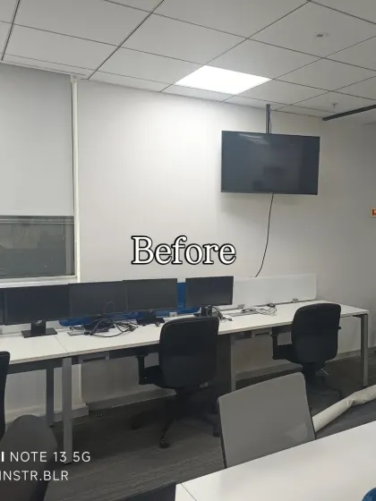 Before: A standard office wall with a TV.