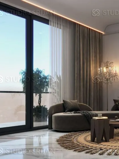 A cozy corner in a Mansarovar Garden lobby, with a plush chaise lounge next to a large window, perfect for relaxing with a view.
