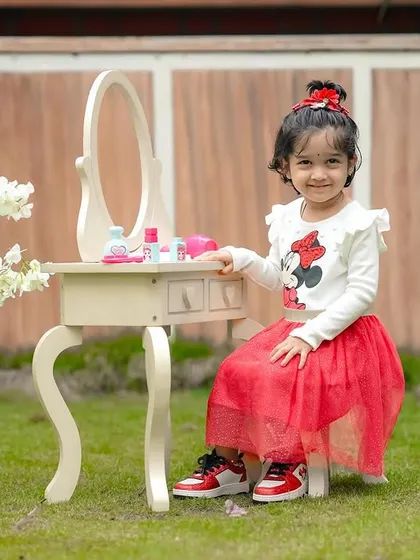 A little lady at her vanity table. We bring our indoor props outside to create whimsical and imaginative scenes in the garden.