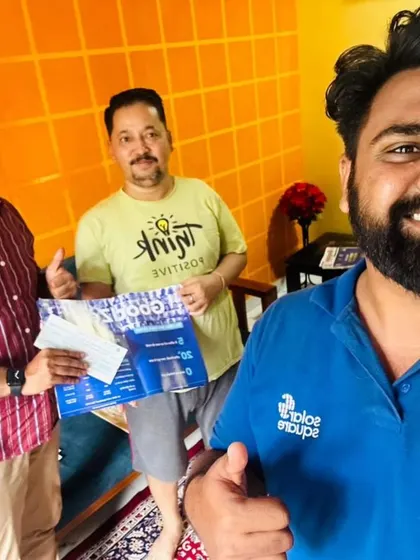 Our team takes a selfie with a customer holding our "GoodZero" brochure.