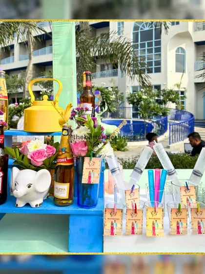 A minimalist yet playful bar corner. We use colorful elements like a bright blue stand, a yellow teapot, and a small elephant statue to add personality to the setup.