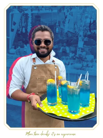 Our mixologist serving a tray of vibrant blue mocktails. Our non-alcoholic creations are colorful, fun, and perfect for daytime events.