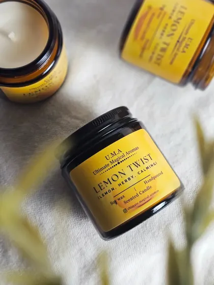 An overhead view of the 'Lemon Twist' candle. The yellow label perfectly complements the bright, refreshing citrus scent inside.