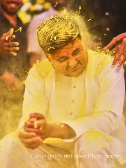 The groom's Haldi is just as fun. This action shot captures the moment he gets completely covered in turmeric, showing the playful side of the tradition.