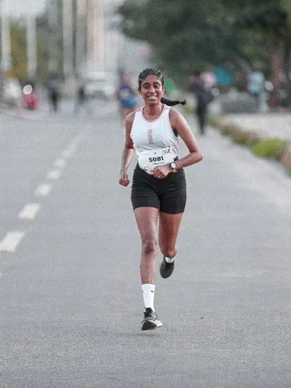 A runner smiles as she cruises along the course during the Freedom Run. Our events are about celebrating the joy of movement and personal achievement.