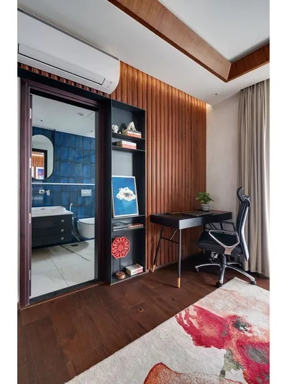 The master bedroom in the "Blue" apartment, showing the custom-designed study nook and the hidden entrance to the bathroom.
