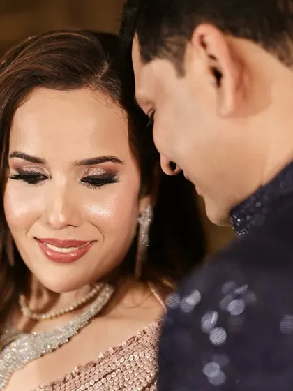 A candid moment from an engagement. The bride's makeup features a shimmery pink smokey eye, perfect for her sparkling pink outfit.