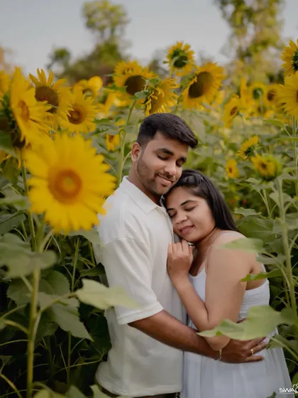 A tender moment as the couple embraces in a sun-drenched sunflower field, perfect for a romantic pre-wedding collection.
