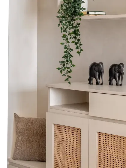 Another detail of the foyer unit, showing the comfortable cushion on the seating bench next to the wicker cabinet.