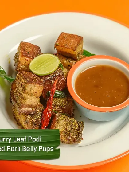 To show the variety on my menu, here are my Curry Leaf Podi Tossed Pork Belly Pops. These are crispy, juicy cubes of pork belly tossed in a flavourful and aromatic curry leaf spice powder, served with a tangy dip.