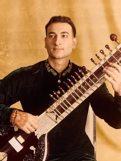 A classic portrait with the sitar, highlighting the detailed embroidery on the kurta.
