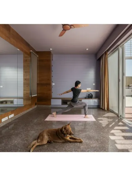 This multipurpose room in the Shivom residence is designed for yoga and exercise, opening onto a terrace and featuring a full-length mirror to enhance the sense of space.