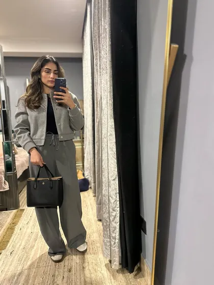 A monochrome grey outfit with a bomber jacket and wide-leg pants.