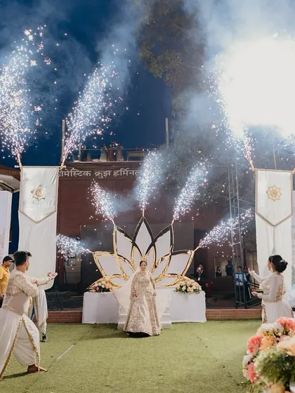 A wide angle view of a magical bridal entry. The combination of dancers, banners, and pyrotechnics creates a grand spectacle for all the guests to witness.