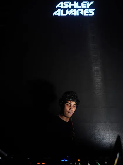 A moody, atmospheric shot of me under my logo. Sometimes the quiet moments in the booth, surrounded by darkness, are just as powerful.