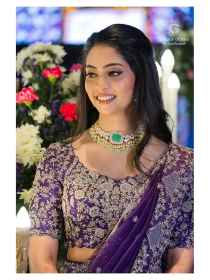 A candid shot of Vidya at her reception. Her makeup looks fresh and beautiful, designed to last throughout the evening's celebrations.