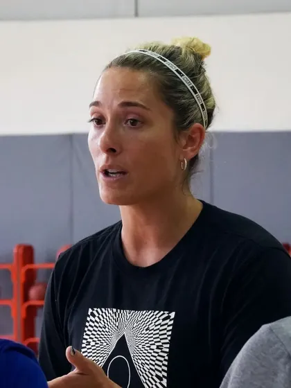 A close-up of Coach Katie Batlin explaining a concept to our women athletes.
