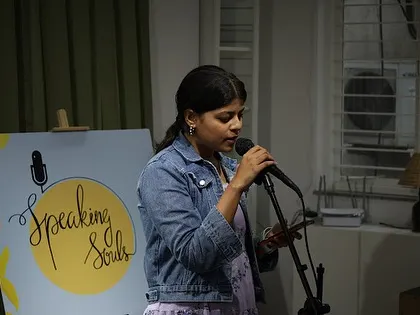 A young artist confidently shares her work at our open mic.