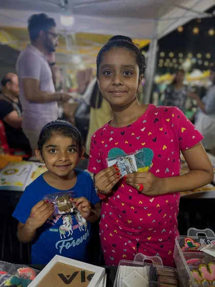 Two young sisters proudly showing off the custom items they got from my stall. Seeing these smiles is why I do what I do.