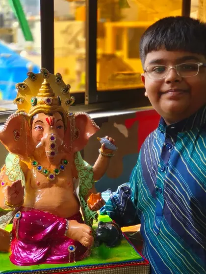 One of our youngest students with the Ganpati idol he painted. Our workshops are family-friendly, offering a creative and spiritual experience for all ages during the festival season.