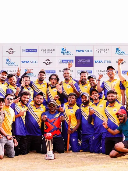 Celebrating success is a key part of every event we organize. Here, a winning team from the Indian Corporate Cricket League poses with their trophy in front of a sponsor wall featuring brands like Daimler Truck, Apollo Hospitals, and Tata Steel.