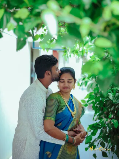 A quiet embrace surrounded by greenery. This candid moment captures the peaceful and deep connection between the couple on their wedding day.