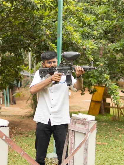 A guest takes aim at the target shooting station. This activity is perfect for those looking to challenge their precision in a fun and competitive setting.