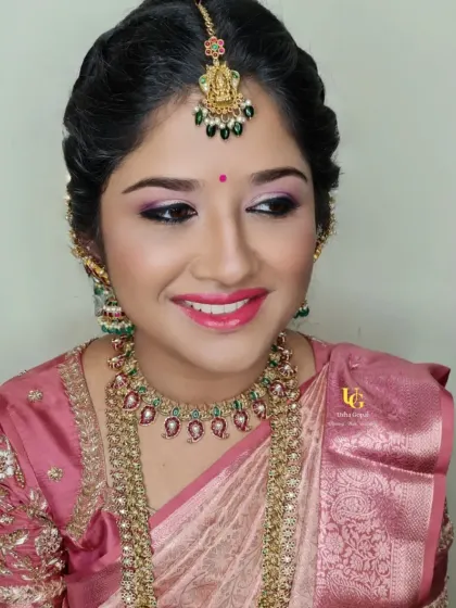My lovely repeat client, Deepthi, looking stunning for a family event. Her soft glam look with pink eyeshadow and a bright smile perfectly matches her beautiful pink silk saree and temple jewelry.