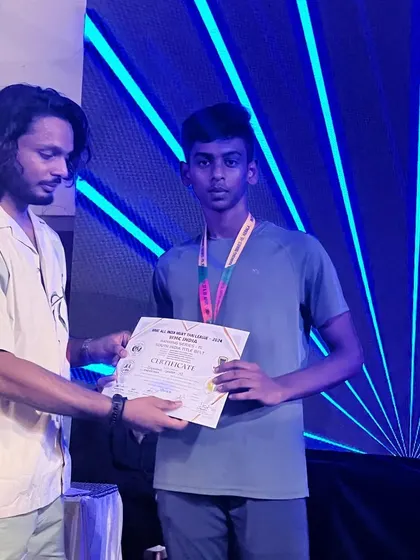 A young team member receiving his certificate at the WMC National Muay Thai Championship.