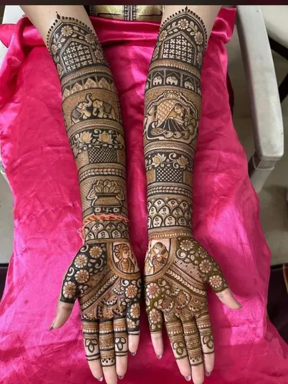 A classic full bridal design with story panels on the arms. It includes a doli scene, elephants, and a 'kalash', with portraits on the palms.