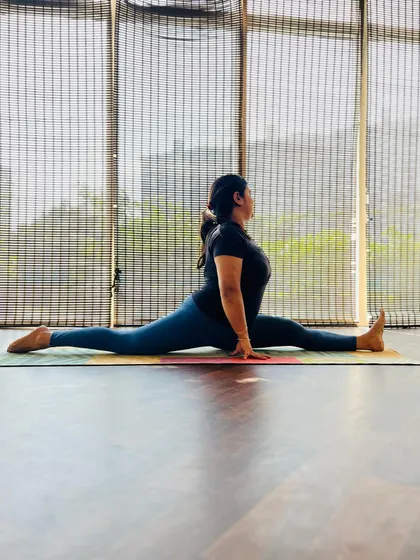 A student holding Hanumanasana in the studio. The journey to full splits is long, but achieving it brings a great sense of accomplishment.