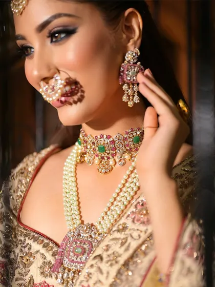 A close-up on the stunning jewellery and the soft, smokey eye makeup. The look is sophisticated and timeless, perfect for a modern bride.