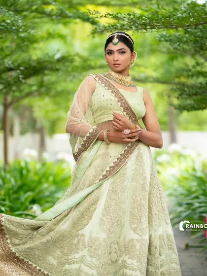 A beautiful pastel green lehenga with delicate chikankari work. This elegant and understated outfit is ideal for a daytime wedding or mehendi ceremony.