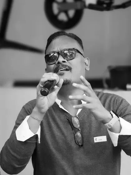 The host keeping the energy high at the Garage Sale. Our events are always lively and engaging.