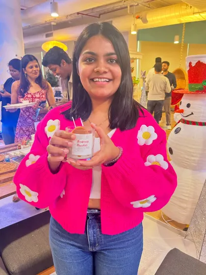 A happy participant shows off the Christmas-themed candle she made at our fundraising event. Our workshops can be themed for holidays and special occasions.