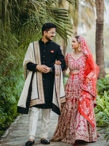 A candid walking shot of the couple, sharing a smile. This type of portrait captures their natural chemistry and the happiness of the moment, making it feel authentic and full of life.