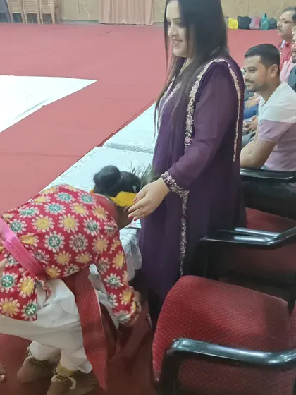 Another angle showing the interaction between our founder and a student performer during the school competition.