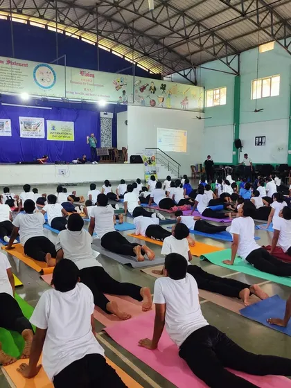Students practicing Bhujangasana (Cobra Pose) in unison at one of our many yoga sessions across Goa.