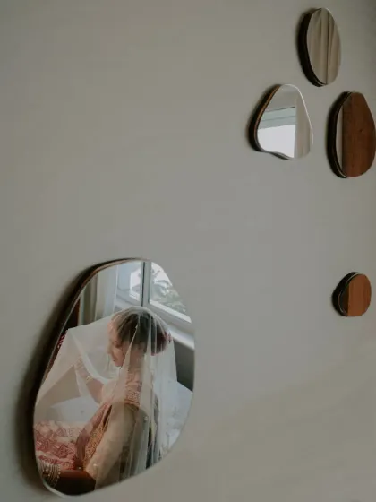 The colored version of the mirror reflection shot, adding warmth and detail to the creative portrait.