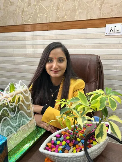 A photo of me at my desk in the clinic. I am passionate about my work and dedicated to helping my patients achieve their skin and hair goals.