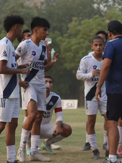 Players taking a water break while receiving instructions from the coach. We emphasize strategy and communication during training and matches.
