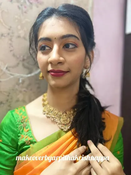 Another angle of this simple party makeup, showing how the soft, pulled-back ponytail and minimal jewelry create a graceful and put-together look.