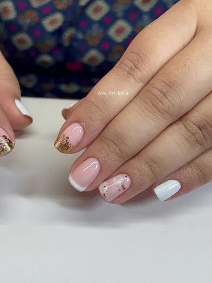 A sophisticated mix of white, French, and gold foil accent nails.